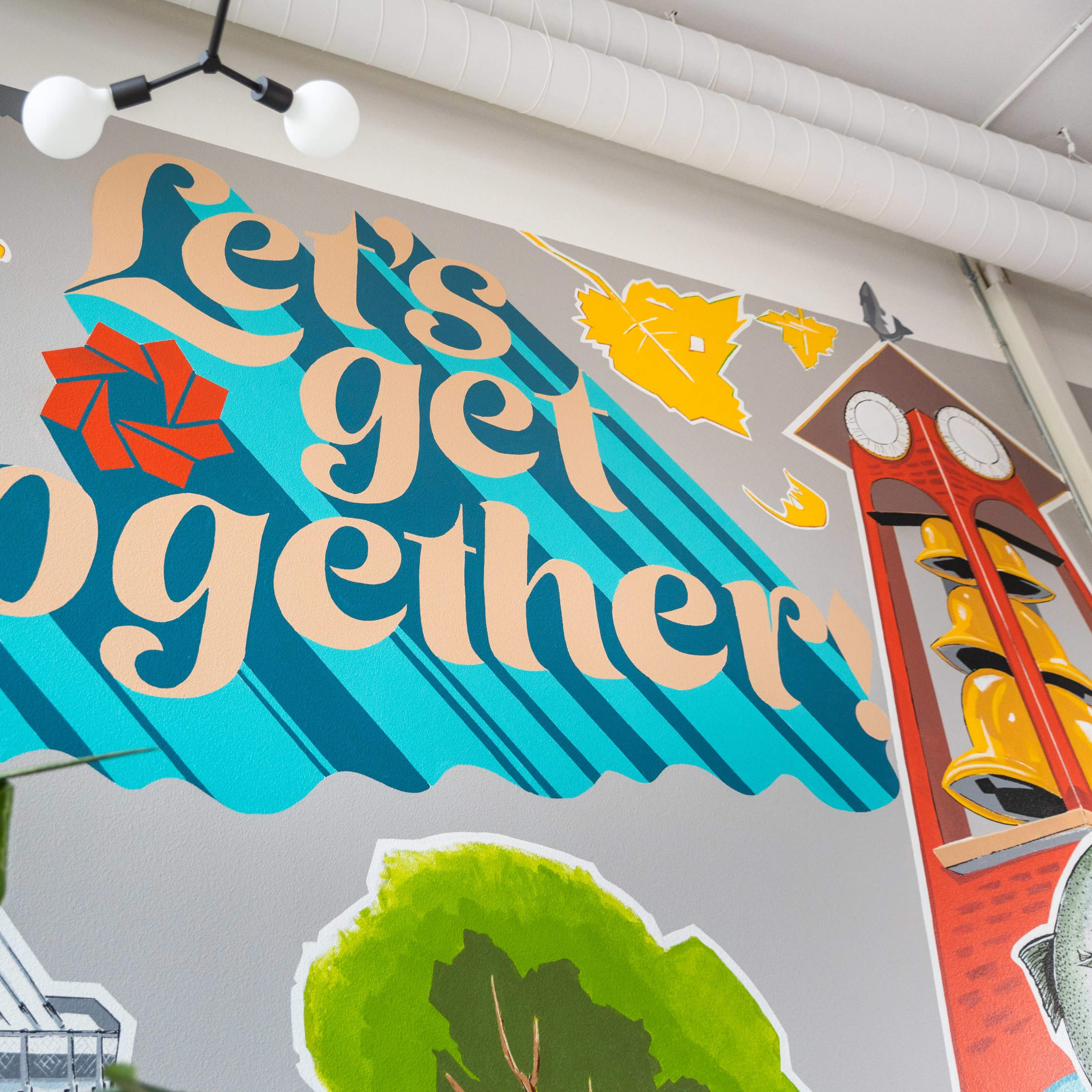 A vibrant mural featuring the phrase "Let's get together," surrounded by colorful illustrations and geometric shapes.