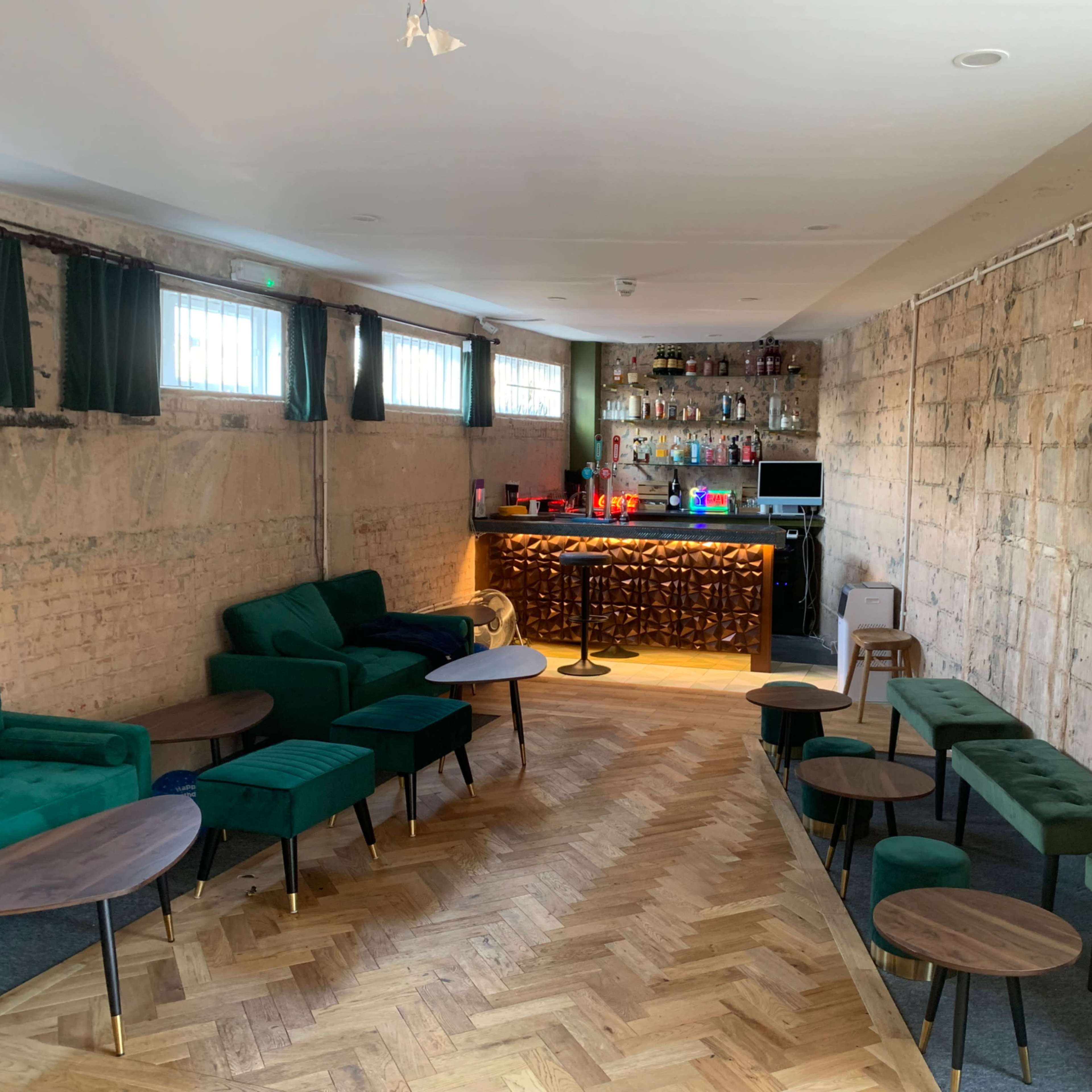 A cool urban first floor cocktail bar and restaurant lounge in a brutalist ex post office building with views over an international street food market Image in Balham, London, England
