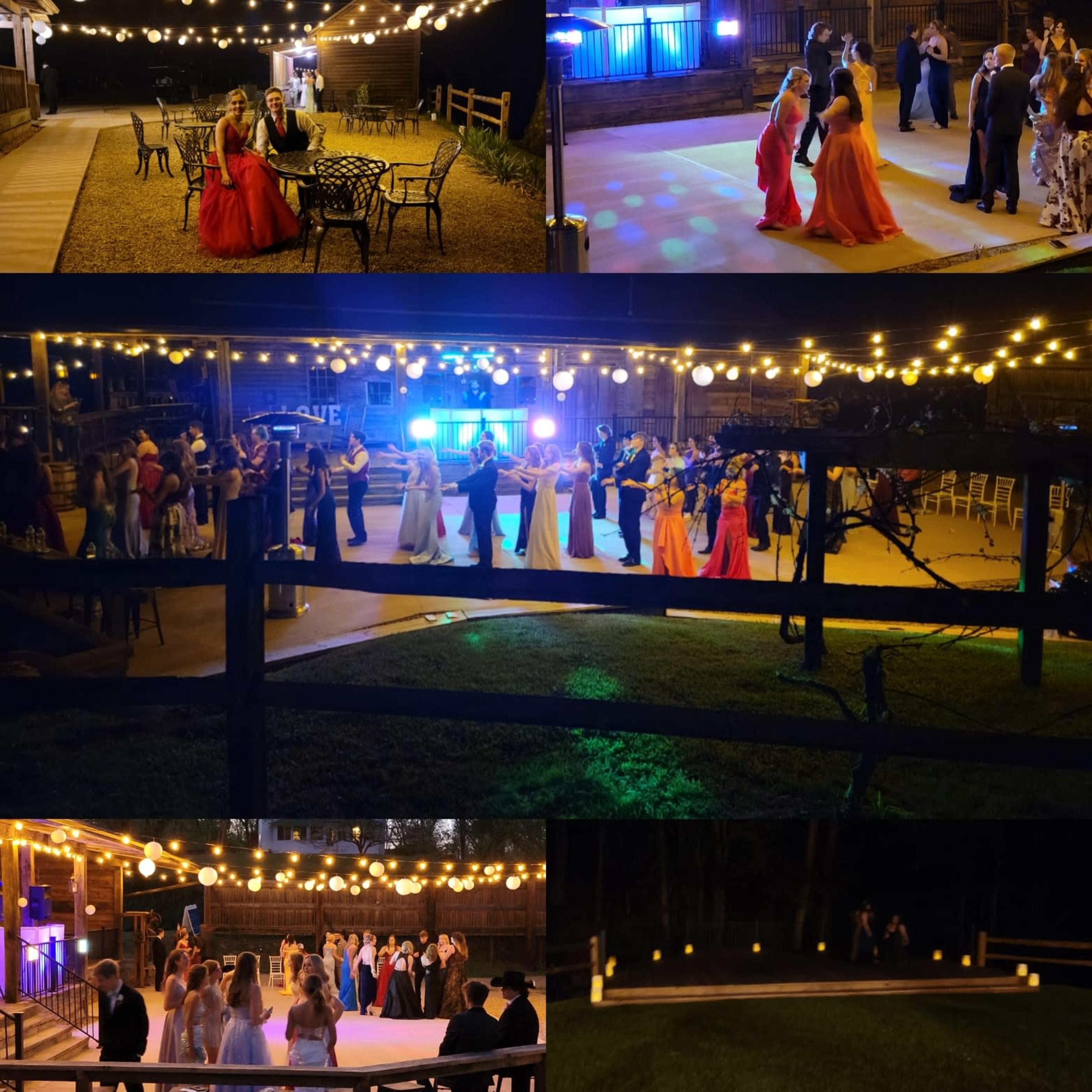 A lively outdoor event with guests dancing and socializing under string lights in a decorated venue.