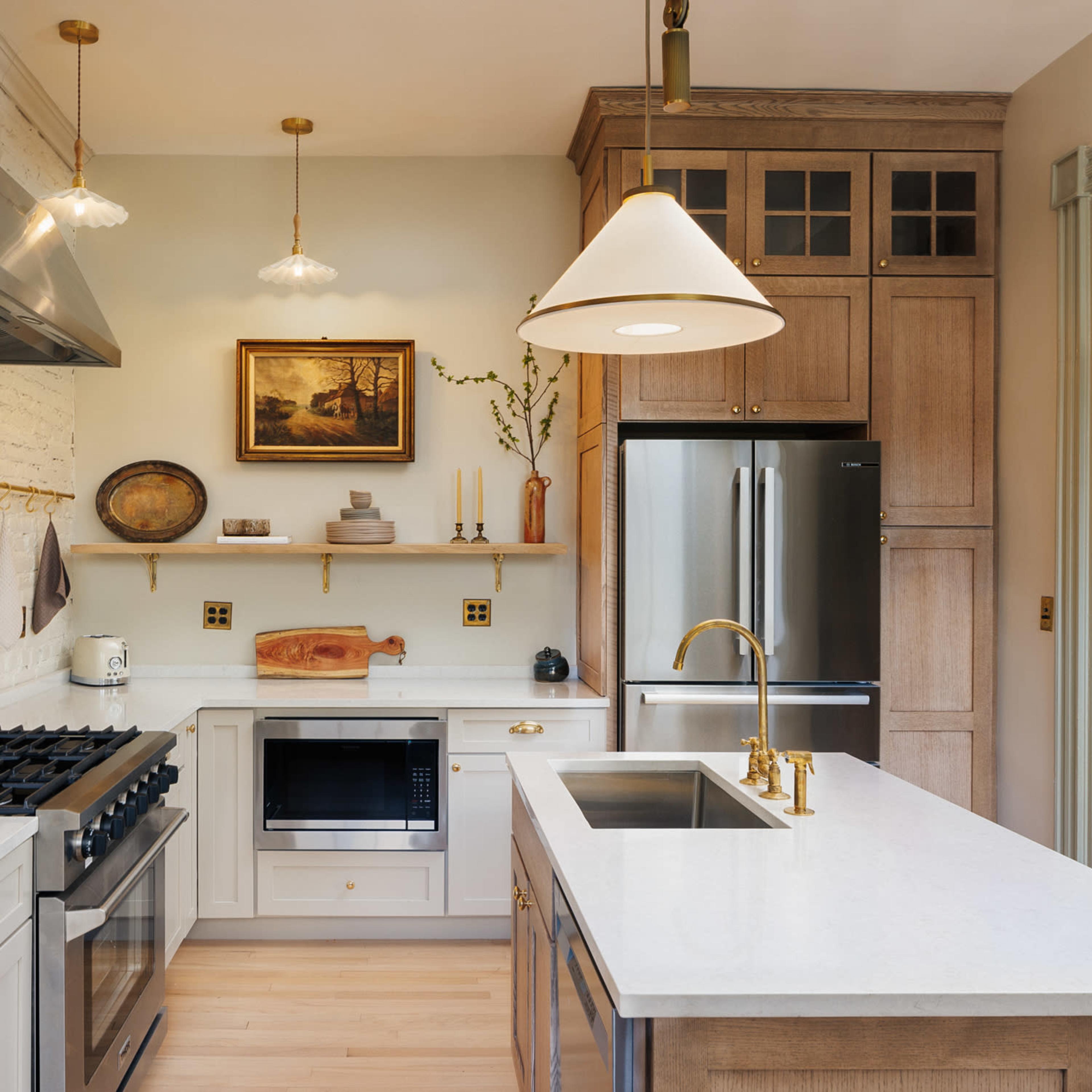 The kitchen features white brick walls, wooden cabinetry, and a central island with a sink and modern appliances.