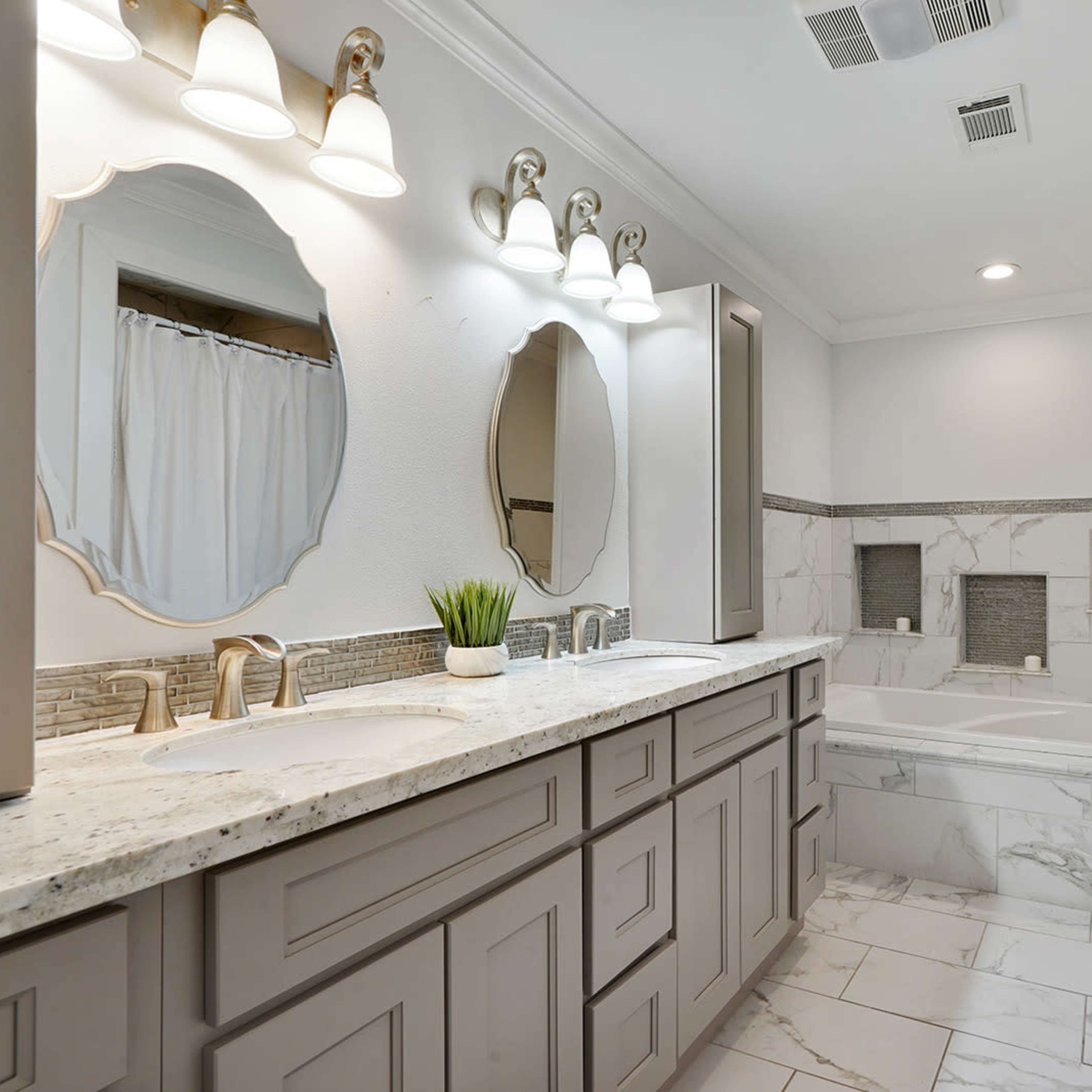 The bathroom features a double vanity with gray cabinetry, a marble countertop, a large bathtub, and a mirror framed in a decorative shape.