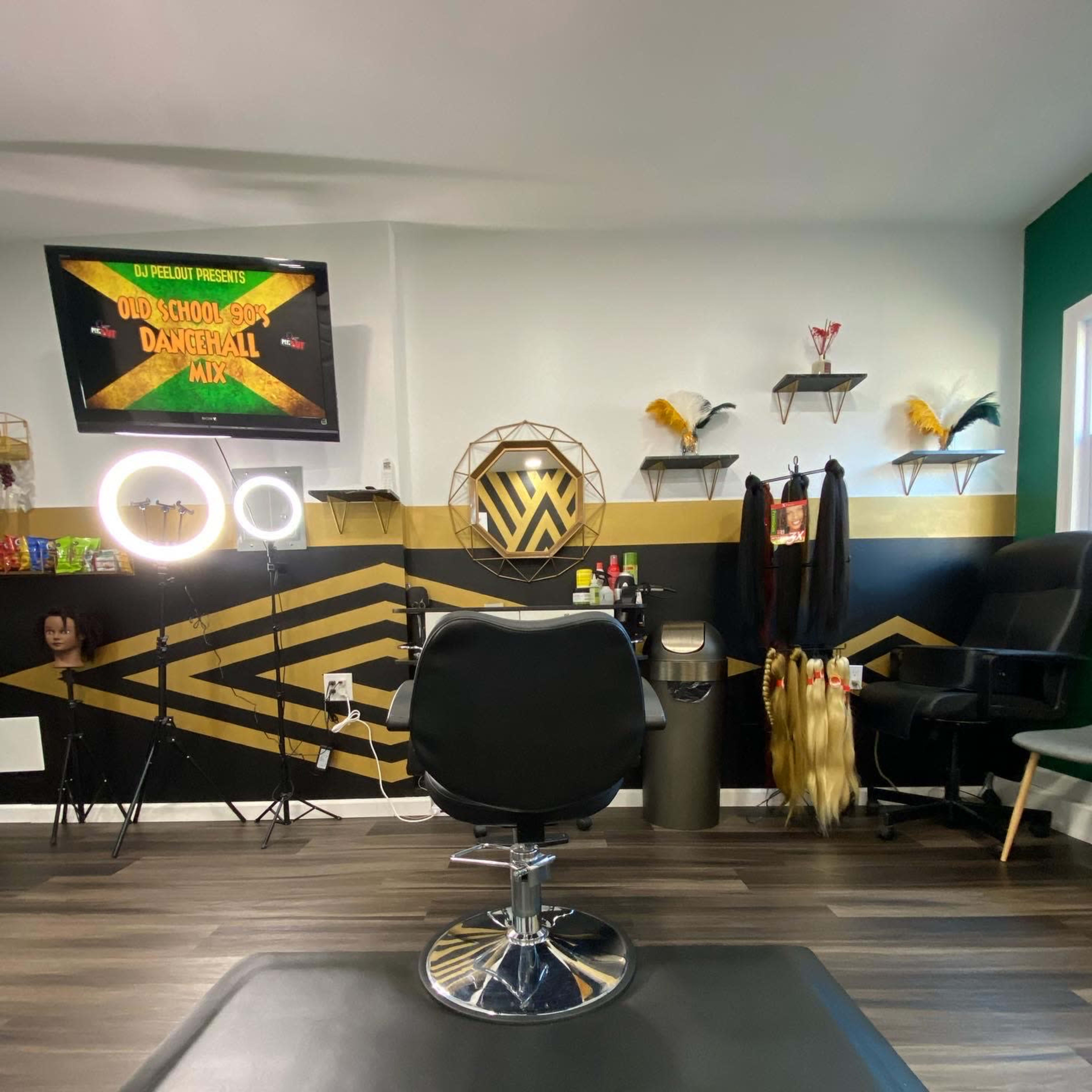 A hair salon interior featuring a stylist chair, a ring light, shelves with hair products, and decorated walls.