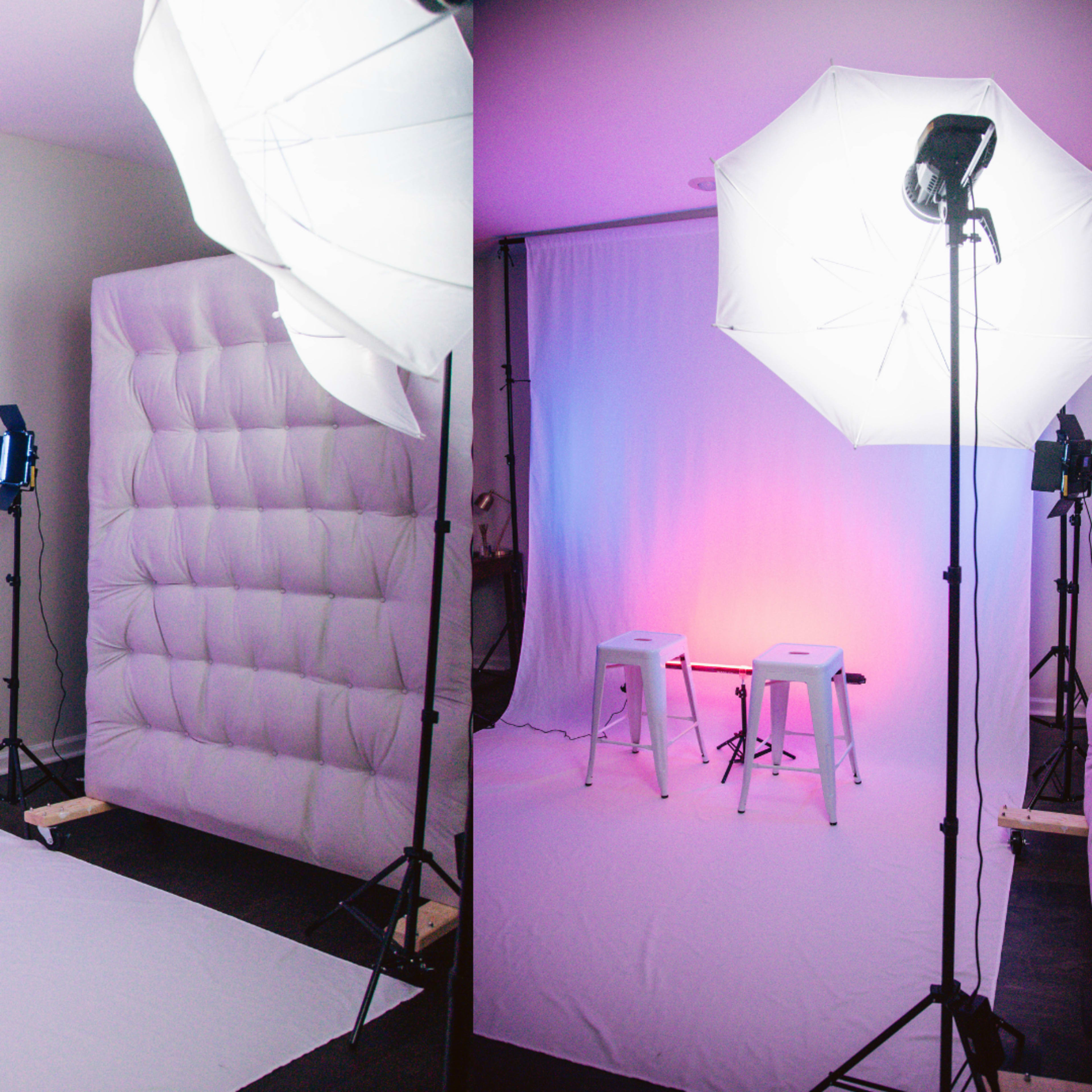 A photography studio setup with two stools placed in front of a plain backdrop, illuminated by softbox lights on either side.