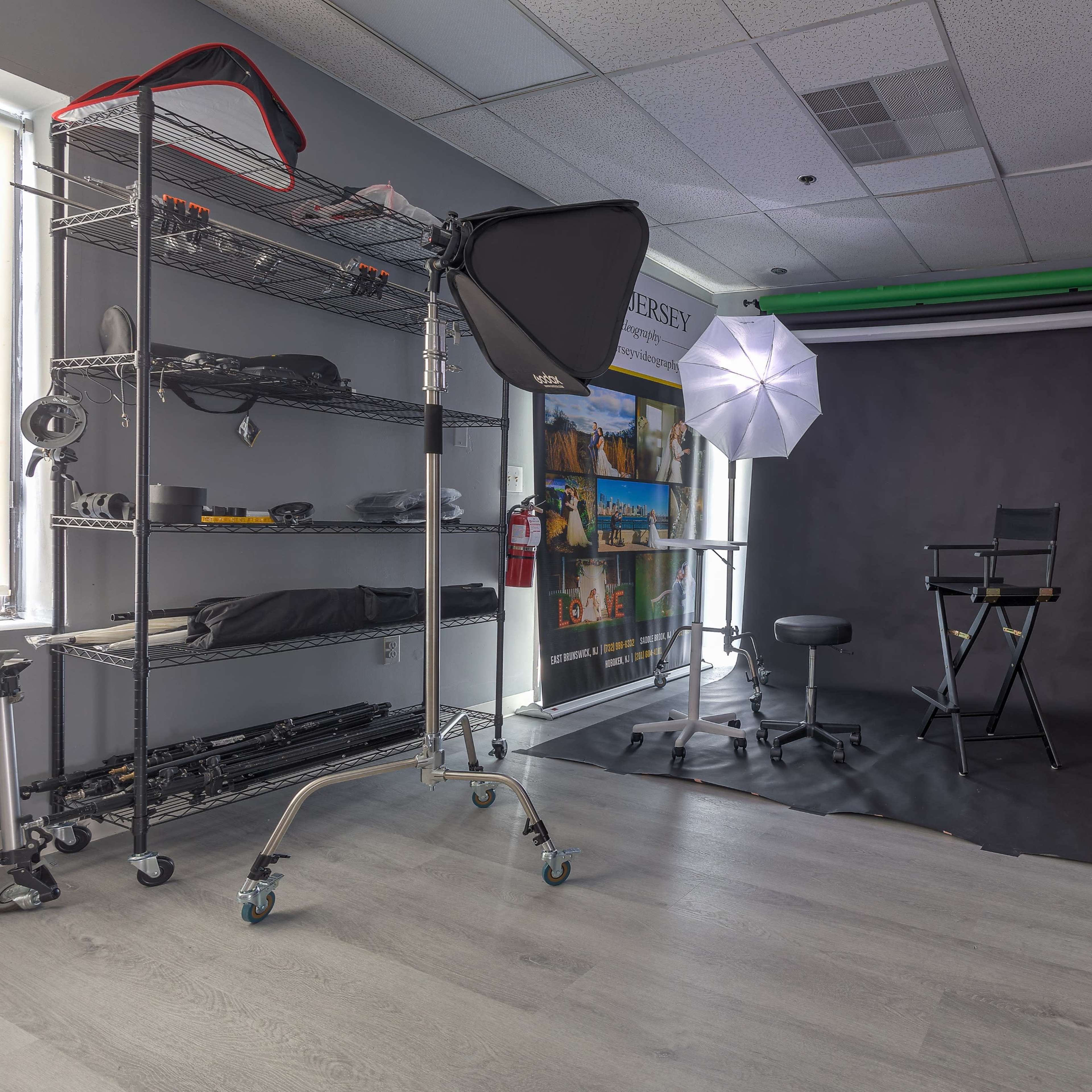 A photography studio setup with lighting equipment, a chair, and a backdrop.