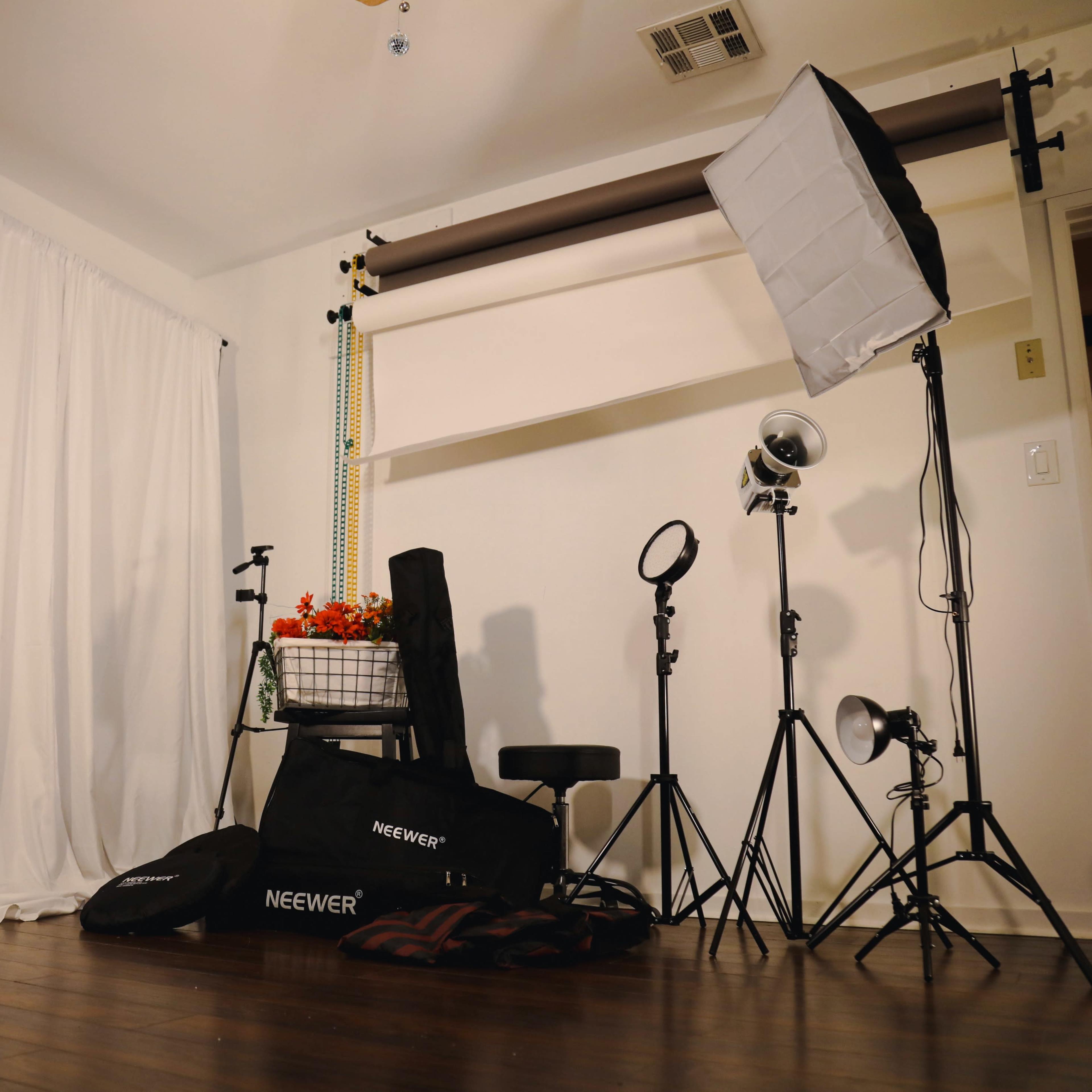 A photography studio setup with lighting equipment, softboxes, and a backdrop, along with a mannequin dressed in clothing.