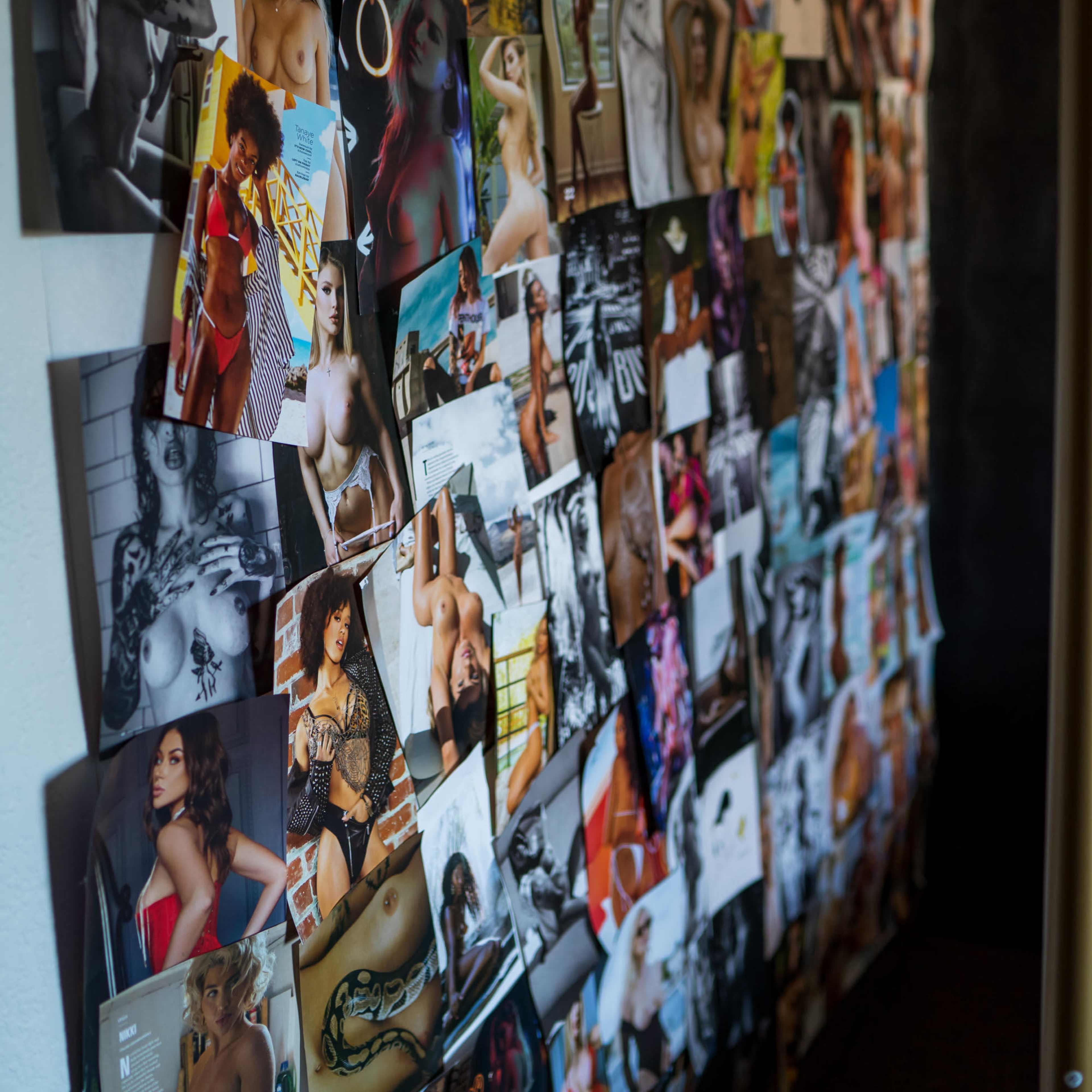A wall is covered with a collage of various photographs featuring people in artistic poses and expressions.