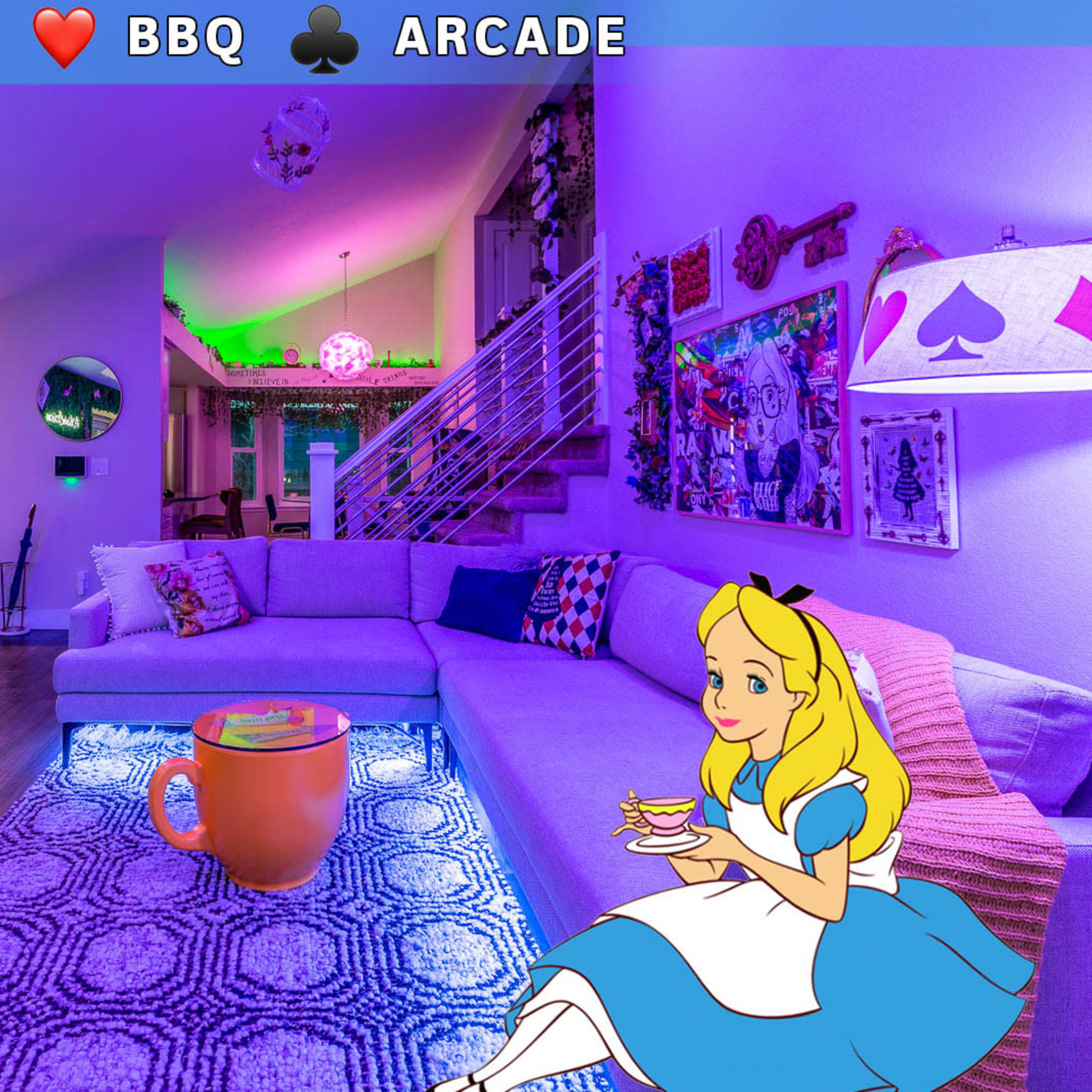 A brightly lit living room with colorful decorations, a large purple couch, and a whimsical animated character sitting beside a oversized tea cup.