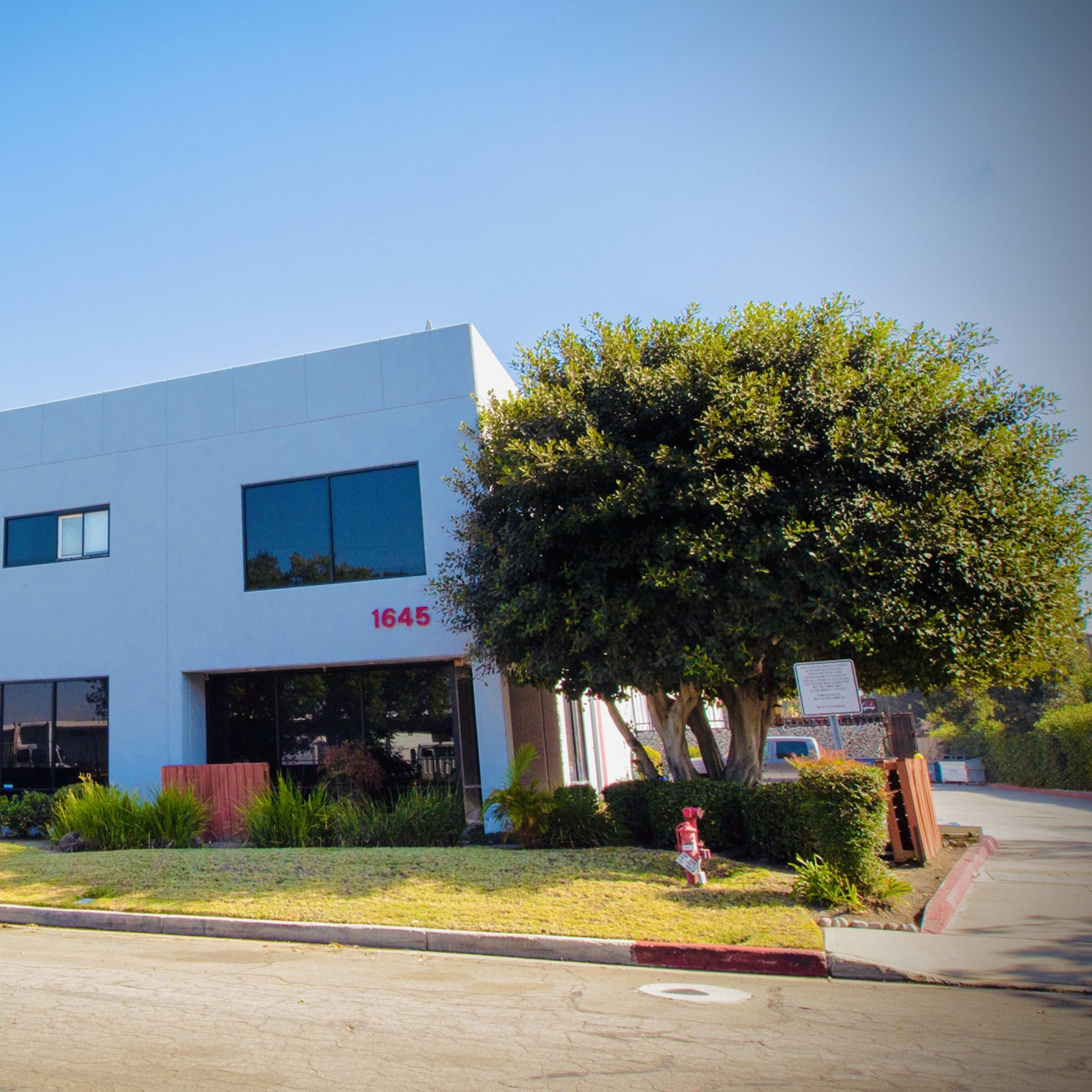 A modern three-story building with large windows and a front lawn is located at 1645.