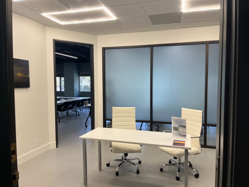 The entry, with a small white table and two chairs set up for check-in.