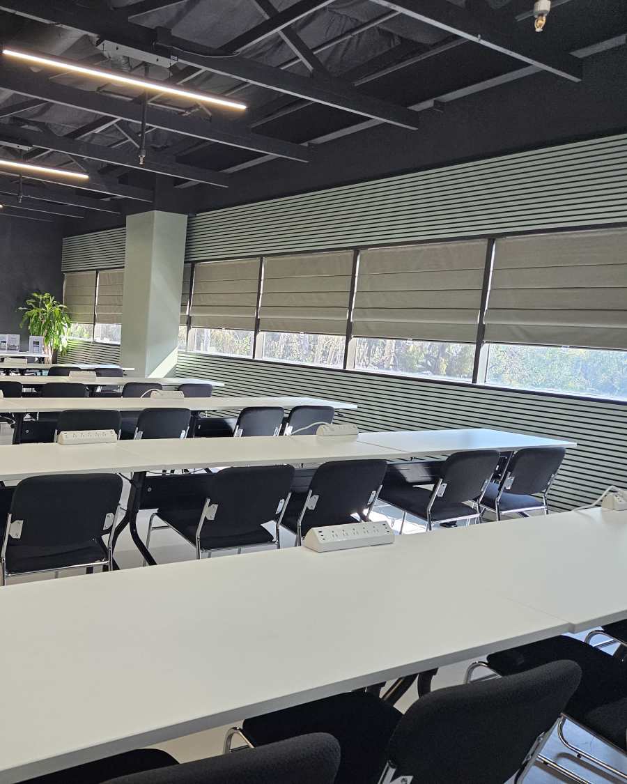 Rows of tables facing the front of the training room, ready for a session.