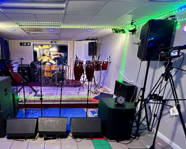 A performance stage equipped with various musical instruments, microphones, and sound equipment.