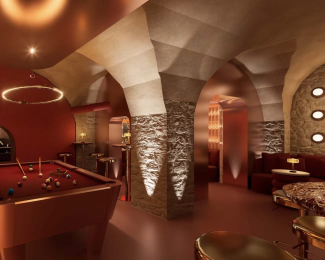 The image features a stylish underground lounge with arching stone walls, a billiards table, and ambient lighting creating a cozy atmosphere.