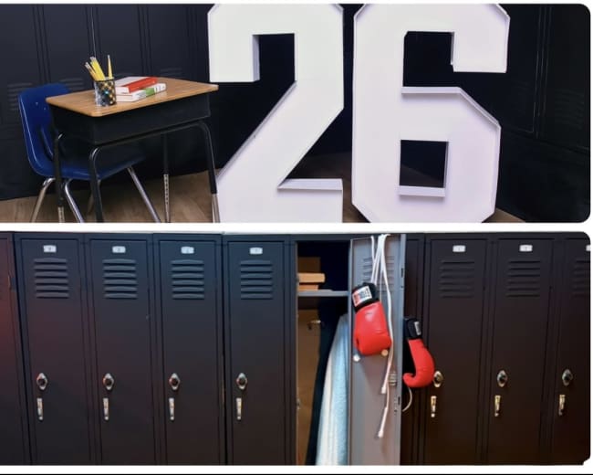 The image features a classroom scene with a desk and large number "26" alongside a row of lockers displaying boxing gloves.