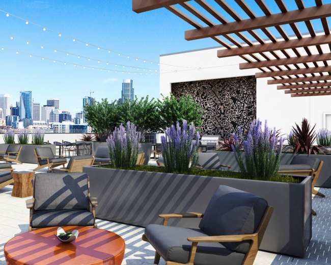 A rooftop terrace features seating arrangements, planters with greenery, and city skyline views under a clear blue sky.