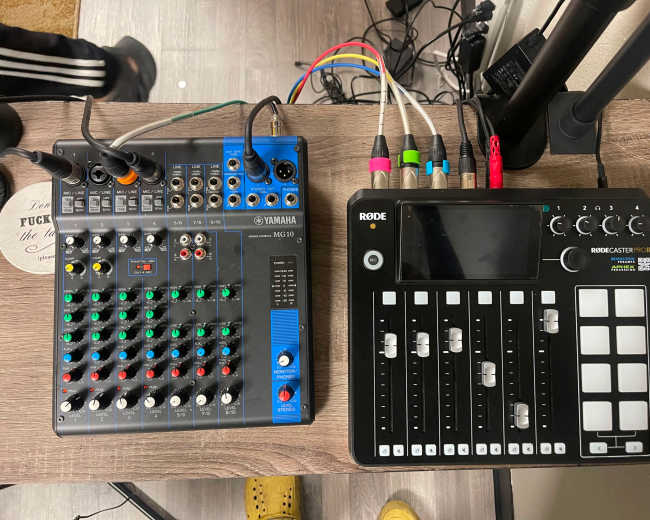 The image shows a Yamaha MG10 audio mixer on the left and a Rodecaster Pro audio production console on the right, both placed on a wooden surface.