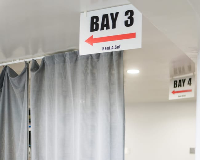 The image shows a partitioned area labeled "BAY 3" with a curtain and an arrow indicating direction, alongside another area labeled "BAY 4."
