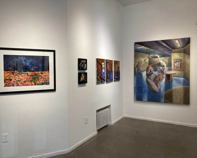 An art gallery wall displaying a variety of framed artworks, including photographs and paintings.