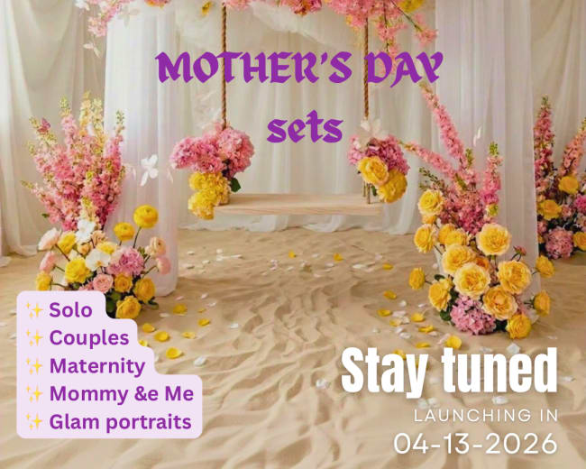 The image features a beautifully decorated photo backdrop with floral arrangements in shades of pink and yellow, featuring swings and signage announcing upcoming Mother's Day photo sets.