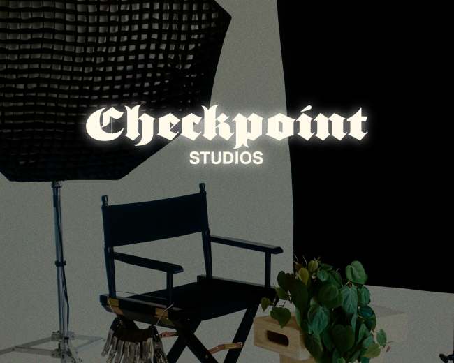 The image features a film set with a director's chair, a plant, and various studio equipment against a dark background.