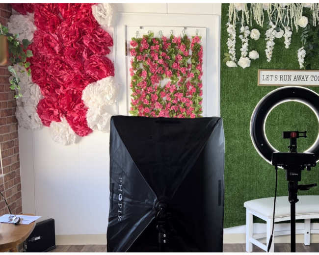 The image features two distinct sections of a decorated room, one adorned with colorful floral arrangements and the other with greenery, a circular ring light, and a small white bench.