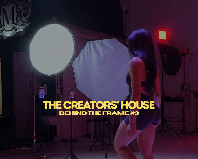 A person stands on a workout platform in a studio setting, with large softboxes and a spotlight illuminating the scene.