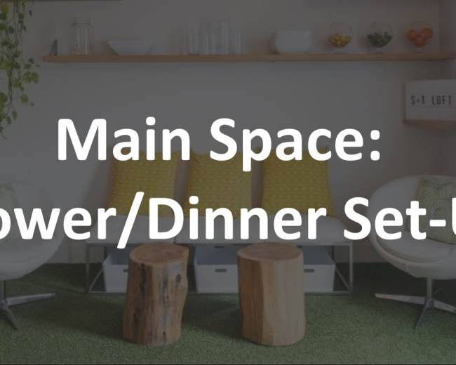 A modern living area featuring two white chairs, two wooden stools, a green area rug, and a shelf with plants and decorative items.