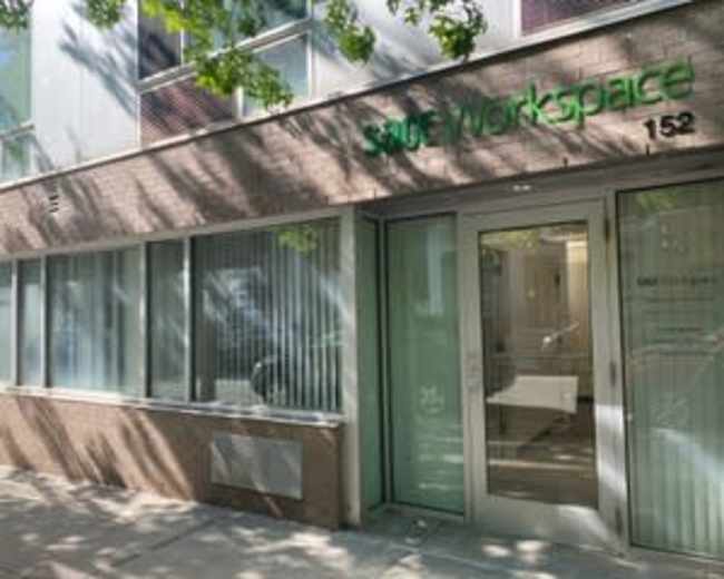 The entrance of a workspace building with large glass doors and the sign "Surf Workspace" prominently displayed.