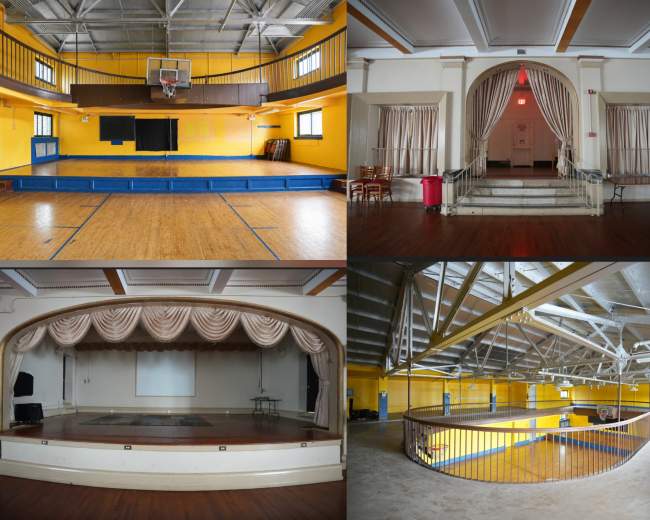 The image showcases a multi-purpose indoor space featuring a basketball court in one corner, a stage with curtains in another, and balconies overlooking the main area.