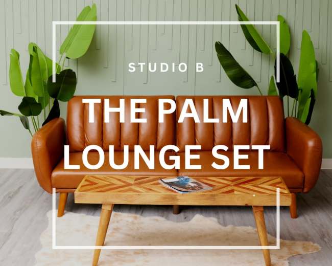 The image features a brown leather sofa with a wooden coffee table set in a room adorned with green leaf motifs on the walls.