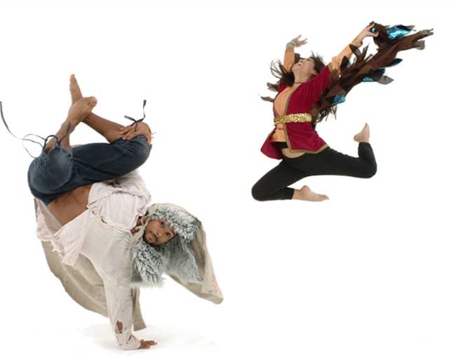 A dancer dressed in a fur-lined hood performs a handstand while another dancer leaps in the air, both set against a white background.