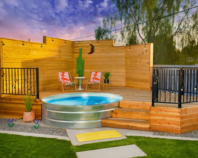 The image shows a wooden deck featuring a circular above-ground pool, surrounded by planters and chairs, with a sunset sky in the background.