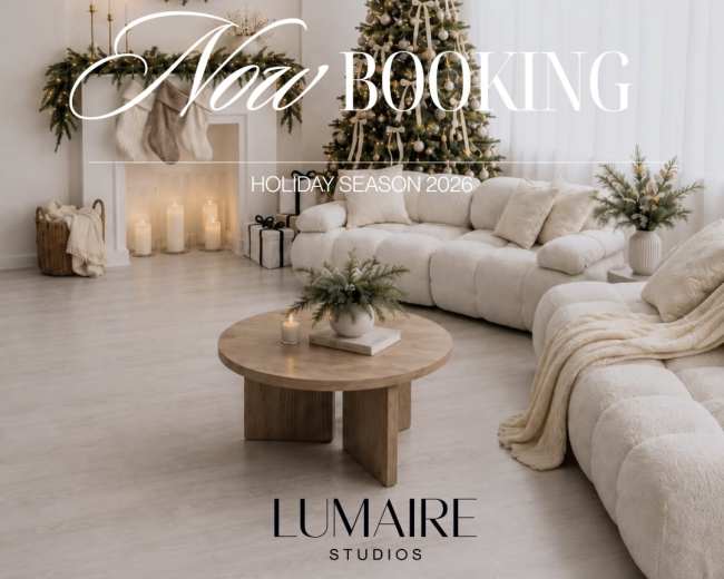 The image features a cozy living room decorated for the holiday season, with a large, plush sofa, a wooden coffee table, and festive greenery.