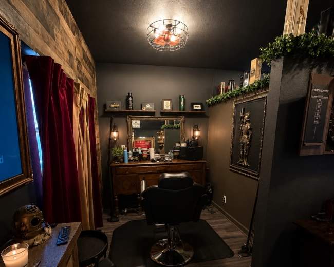 The image shows a dimly lit barbershop interior with wooden paneling, a vintage barber chair, and various grooming products displayed on shelves.