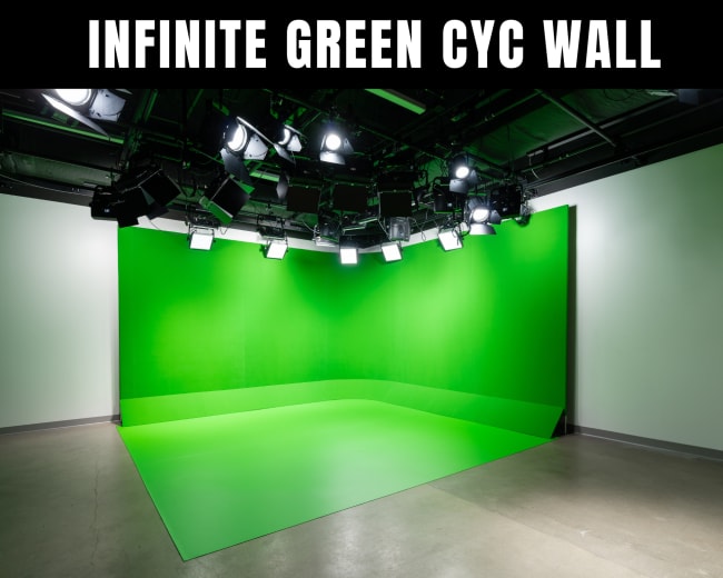 The image shows a green cyclorama wall in a studio space, designed for video and photography production.