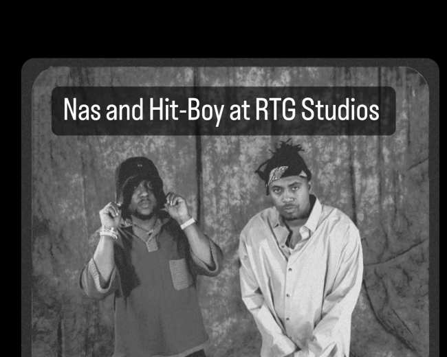 Two men, Nas and Hit-Boy, posing in front of a draped backdrop at RTG Studios.