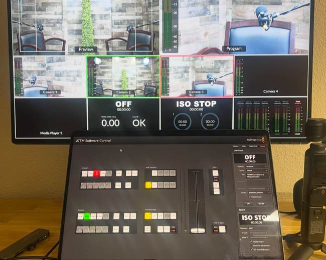 The image shows a multi-screen setup displaying video feeds and controls for a live streaming or broadcasting session.
