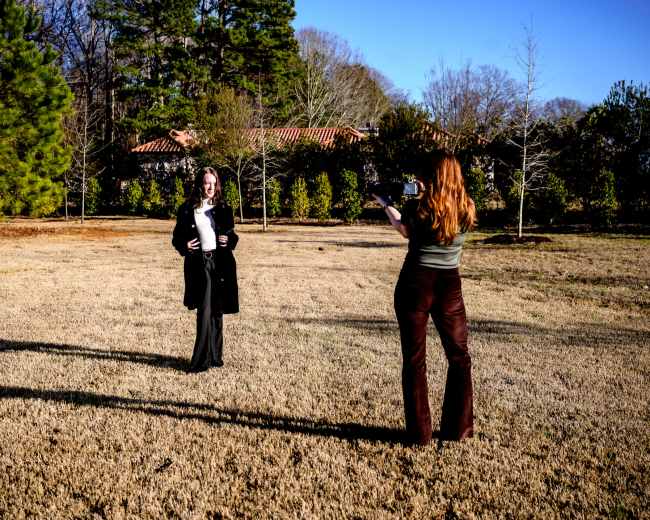 A photography studio equipped with various lighting setups, backdrops, and photography equipment.