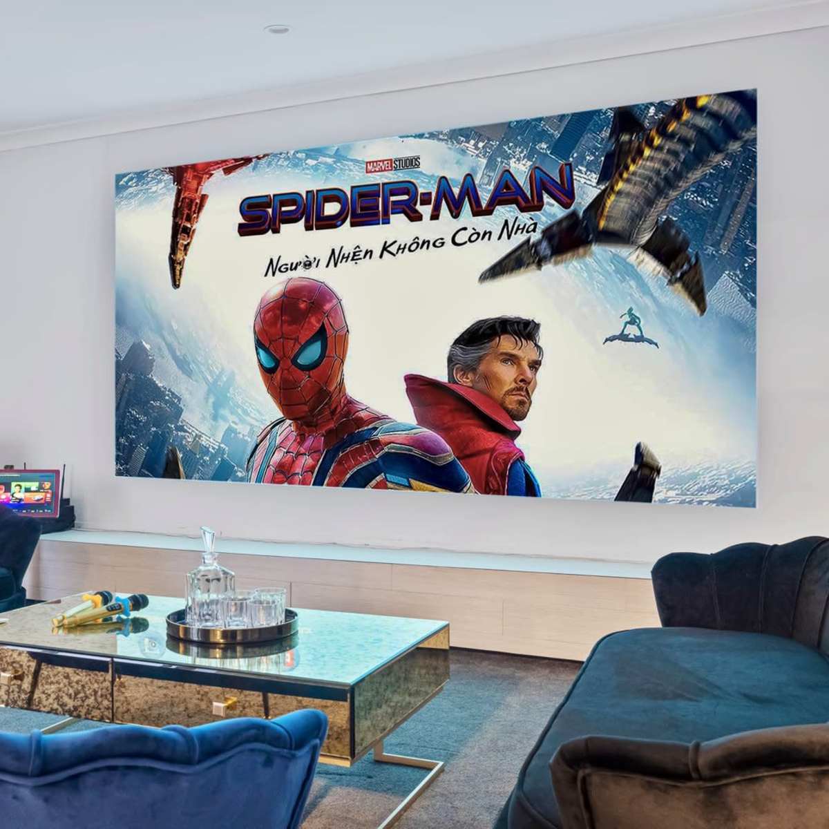 A modern living room with a large poster of Spider-Man and Doctor Strange on the wall and a coffee table with a glass setup in the center.