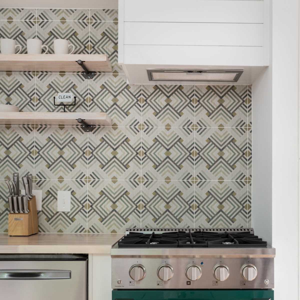 The kitchen features a green Kucht stove with a patterned backsplash, stainless steel appliances, and open shelving above a countertop.