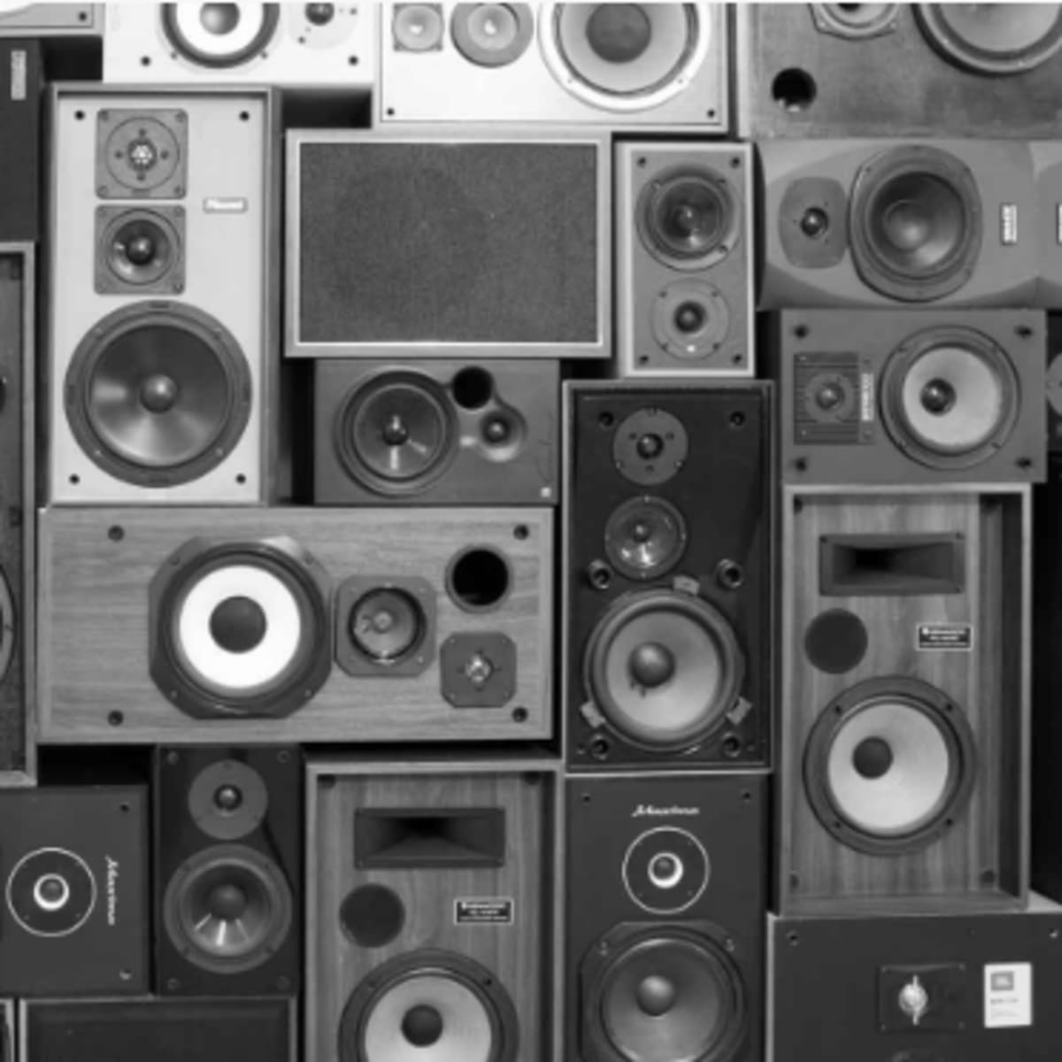 A collection of various vintage and modern speaker cabinets arranged in a grid pattern.