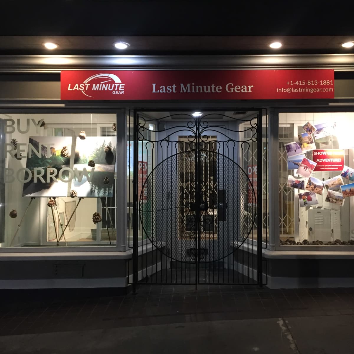 The storefront of "Last Minute Gear" features a decorative gate and displays showcasing rental gear and adventure-themed posters.