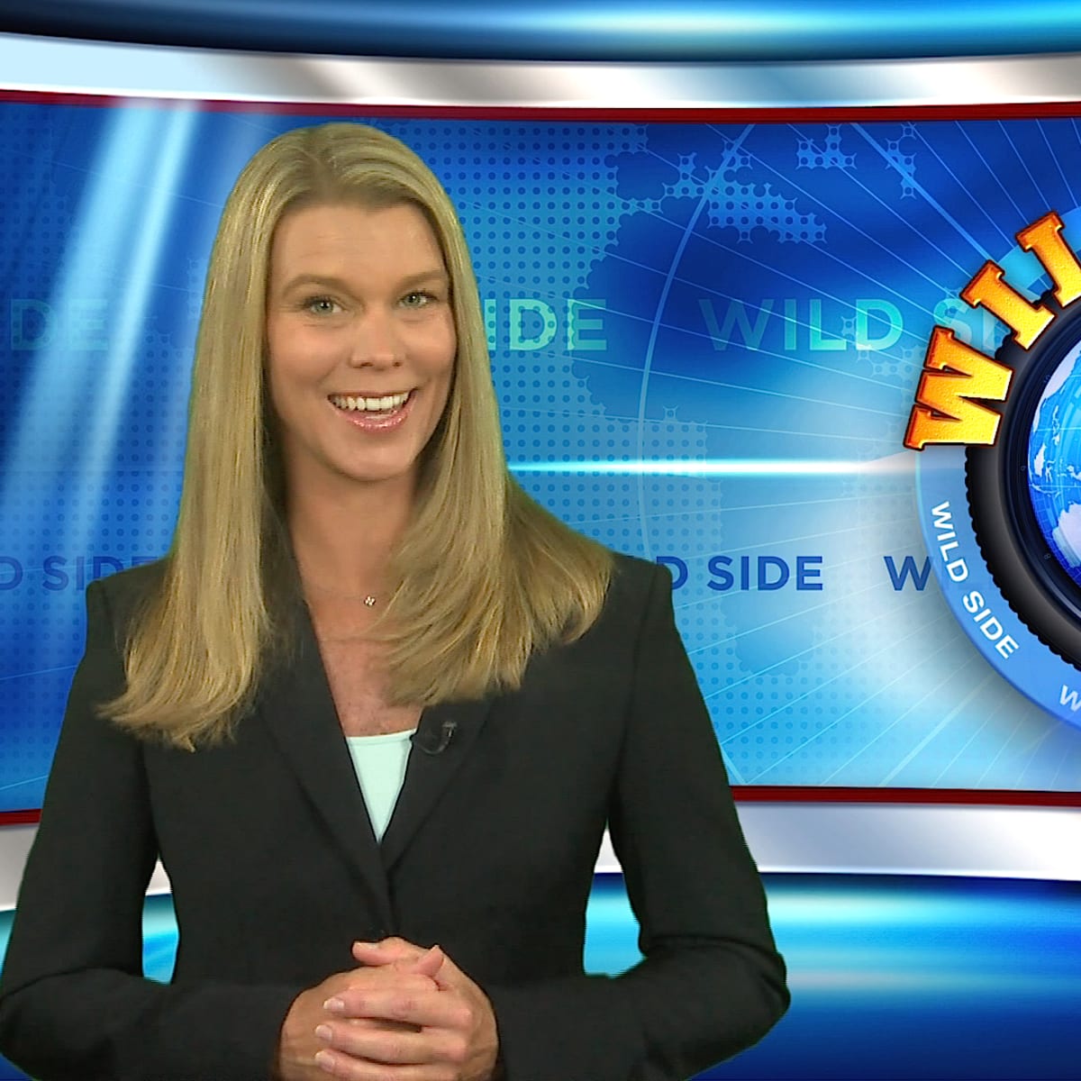 A woman in a black blazer stands in front of a colorful broadcast backdrop featuring the words "WILD SIDE" and a globe.