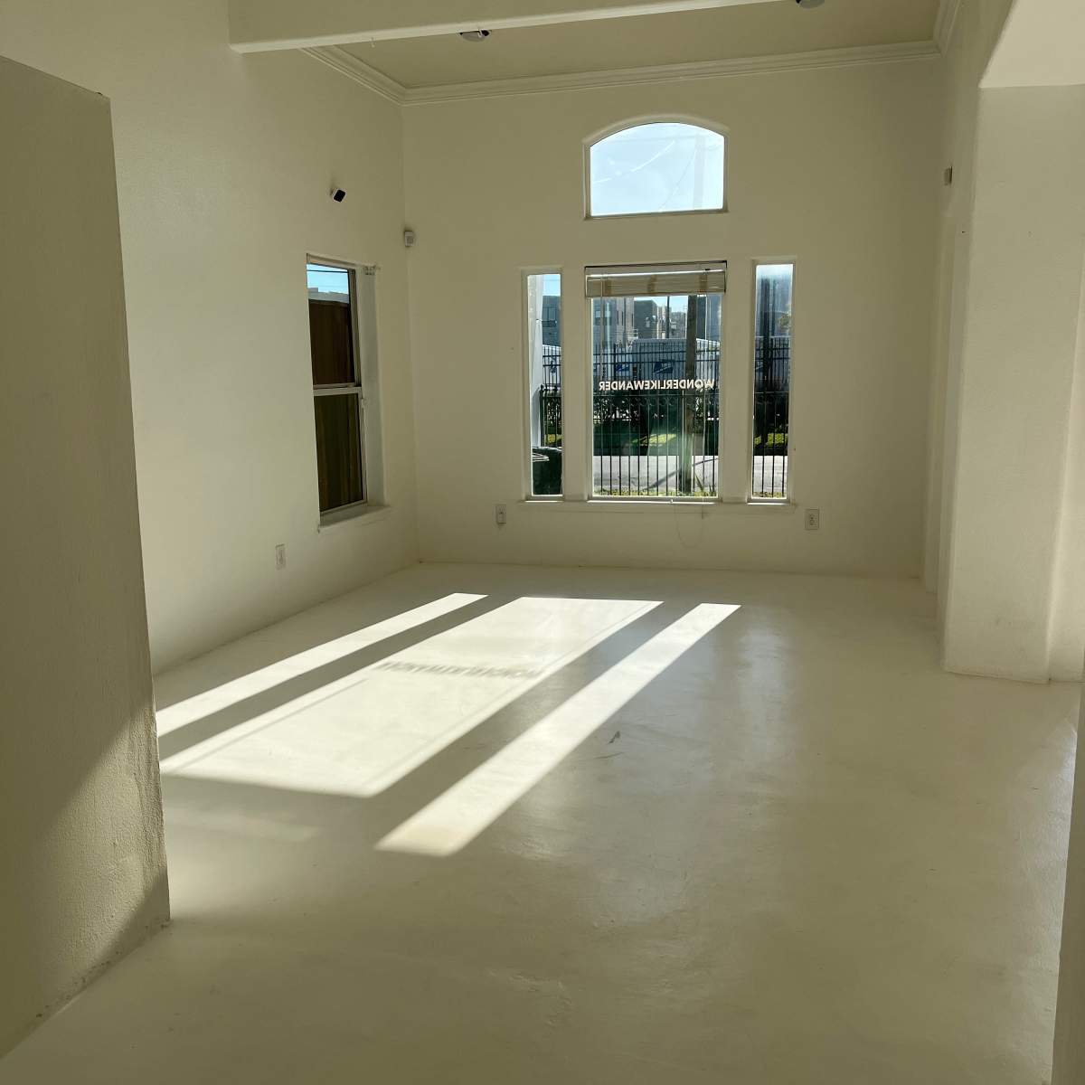 The room features white walls, a smooth floor, and large windows letting in natural light.
