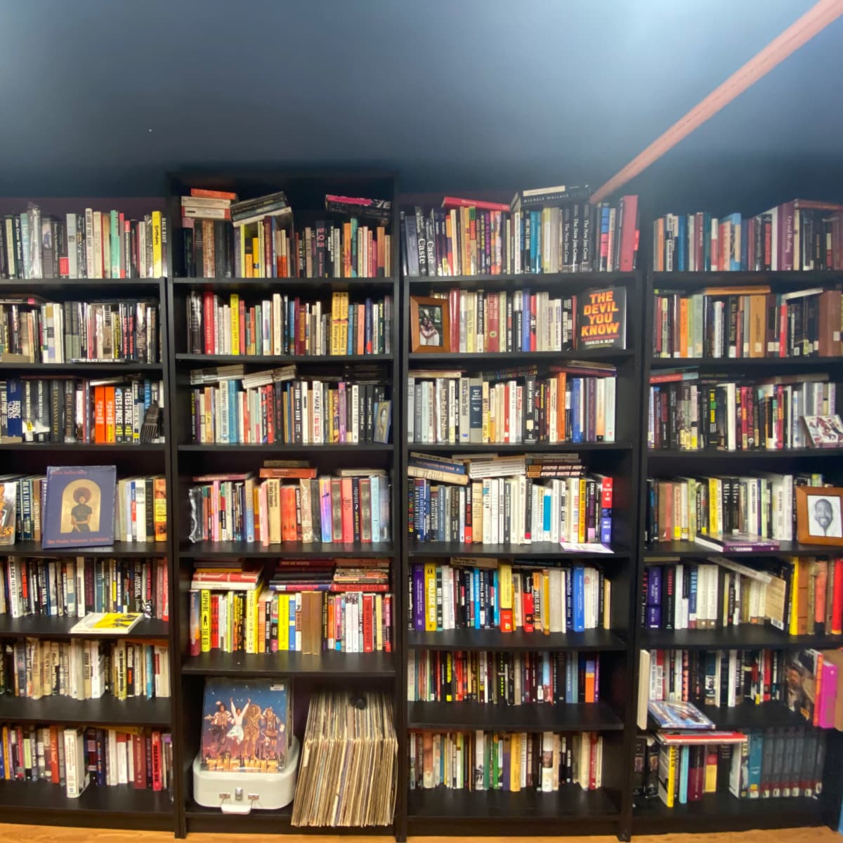 A large bookshelf filled with numerous books organized across multiple shelves in a room.