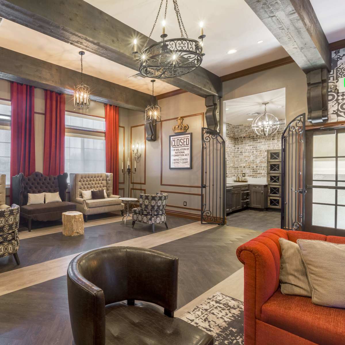 A cozy lounge area with plush seating, decorative lighting, and warm wooden beams, featuring a mix of contemporary and rustic design elements.