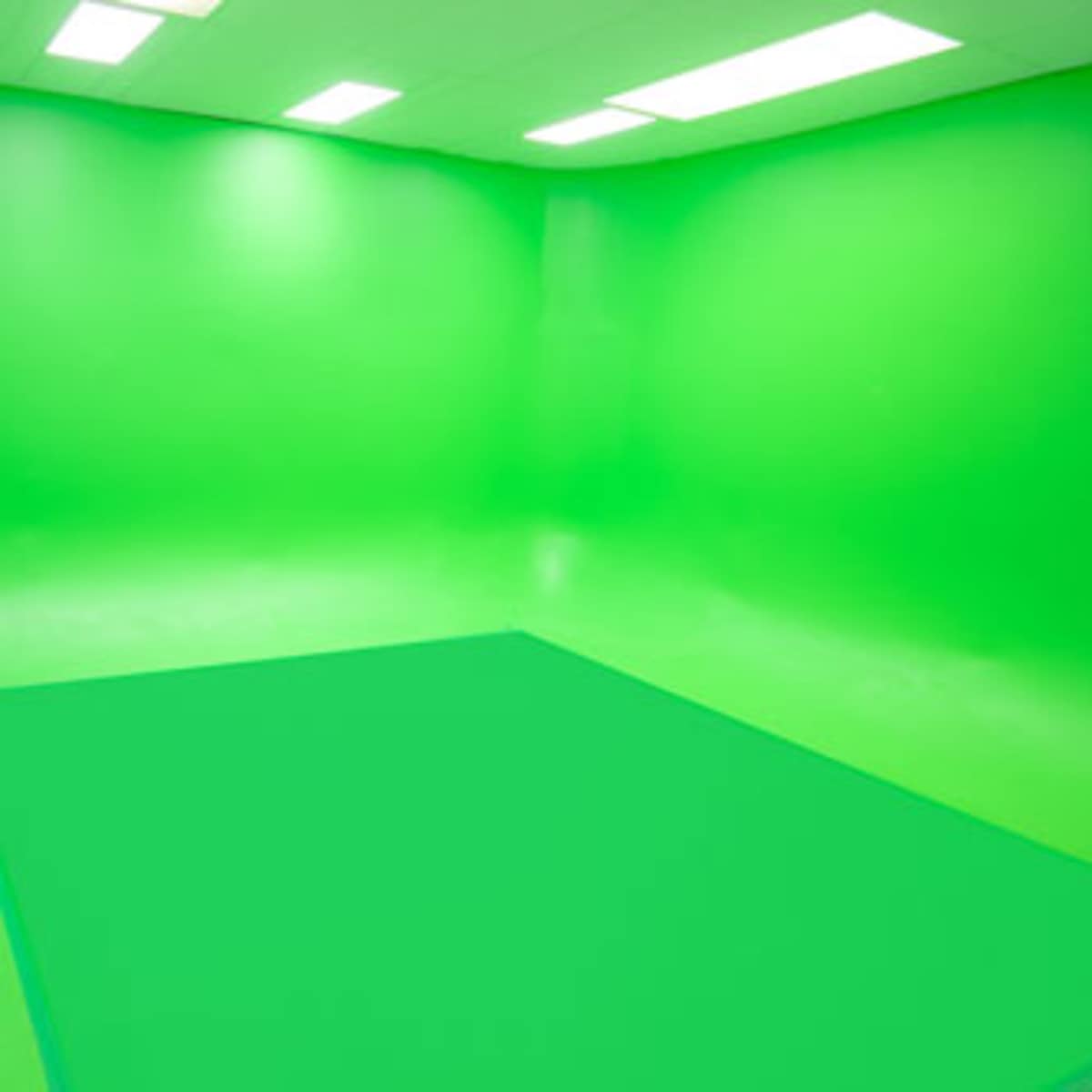 A green studio space with seamless green walls and flooring.