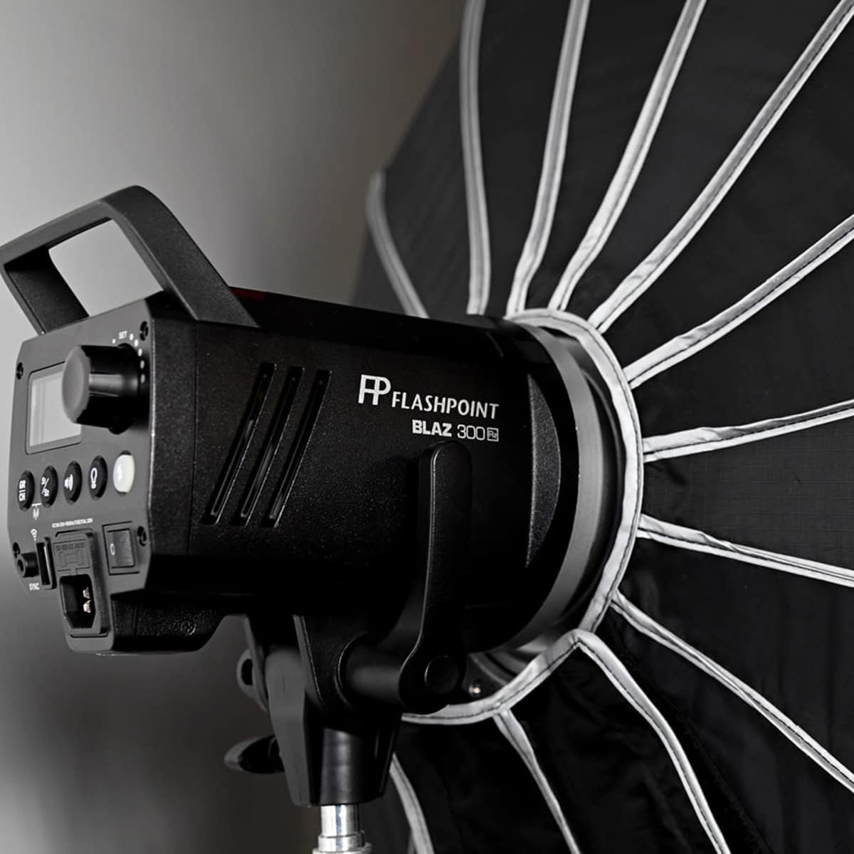A black umbrella softbox attached to a lighting unit, designed for photography.