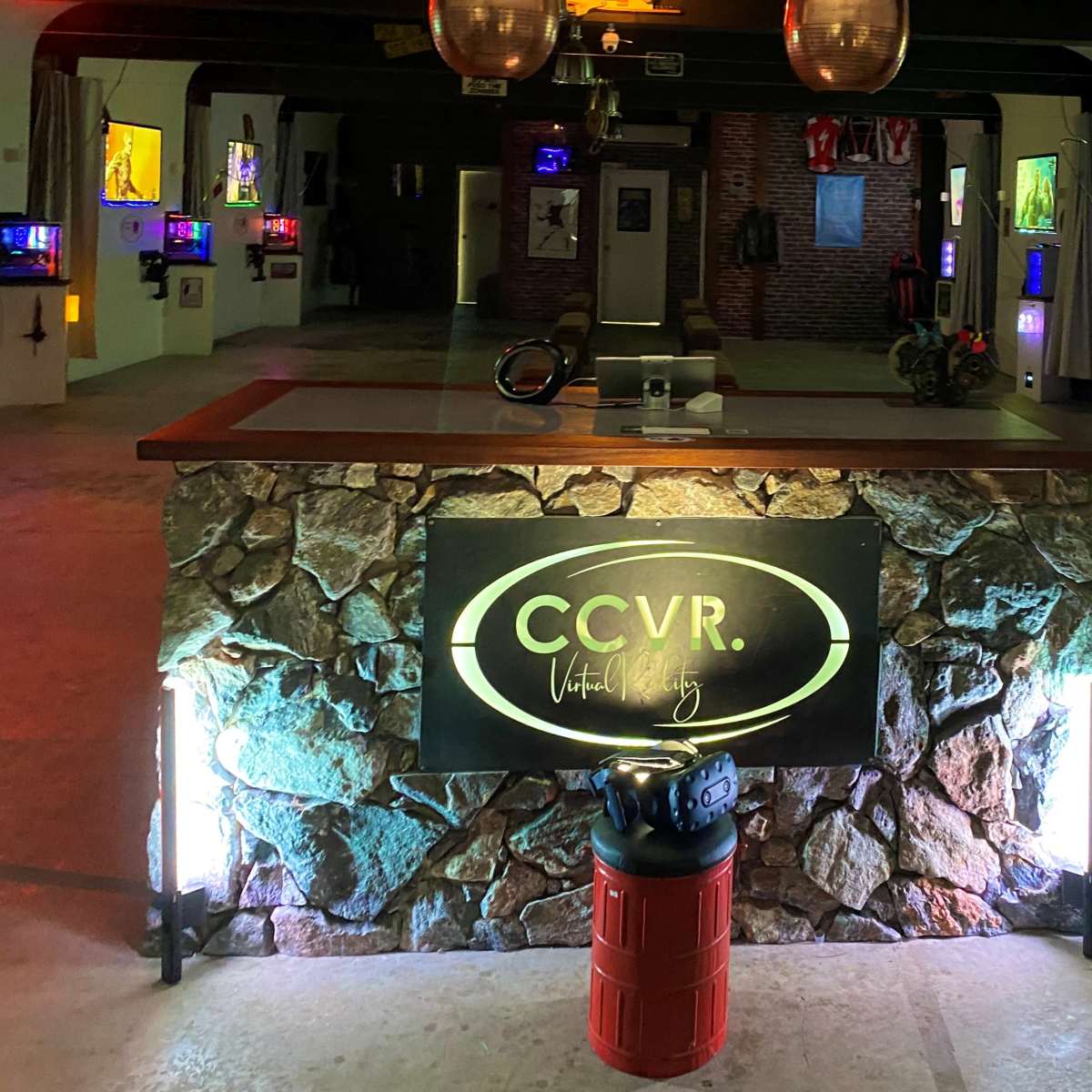 A stone counter with a sign reading "CCVR" in a brightly lit room adorned with colorful artwork and displays.