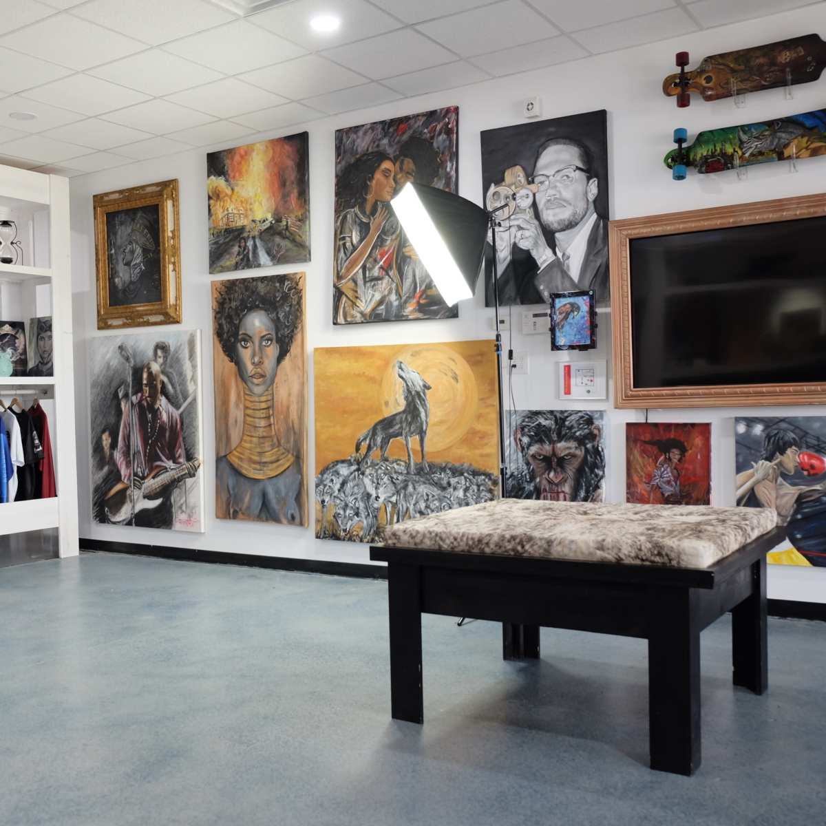 The scene features an art gallery-like space with various paintings on the walls, a display of clothing, and a large screen mounted on one side.