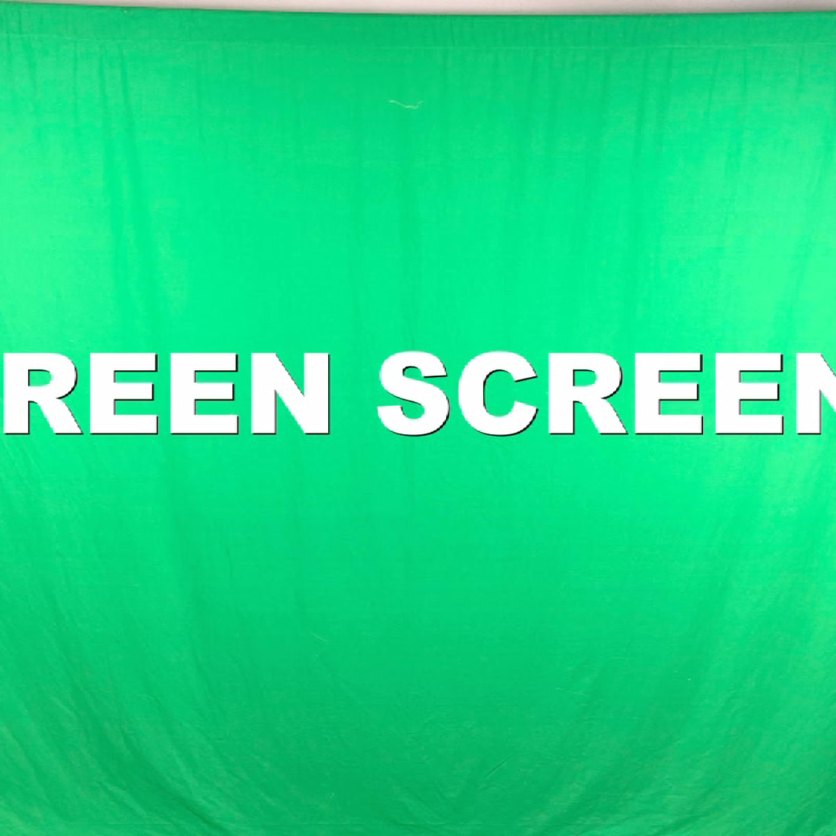 A bright green screen set up for video production, with the words "GREEN SCREEN" displayed prominently in white letters.